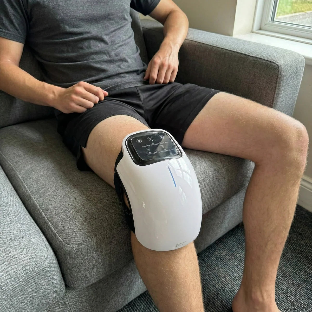 Relaxing on the couch with the Auraloa Knee Relief Pro™